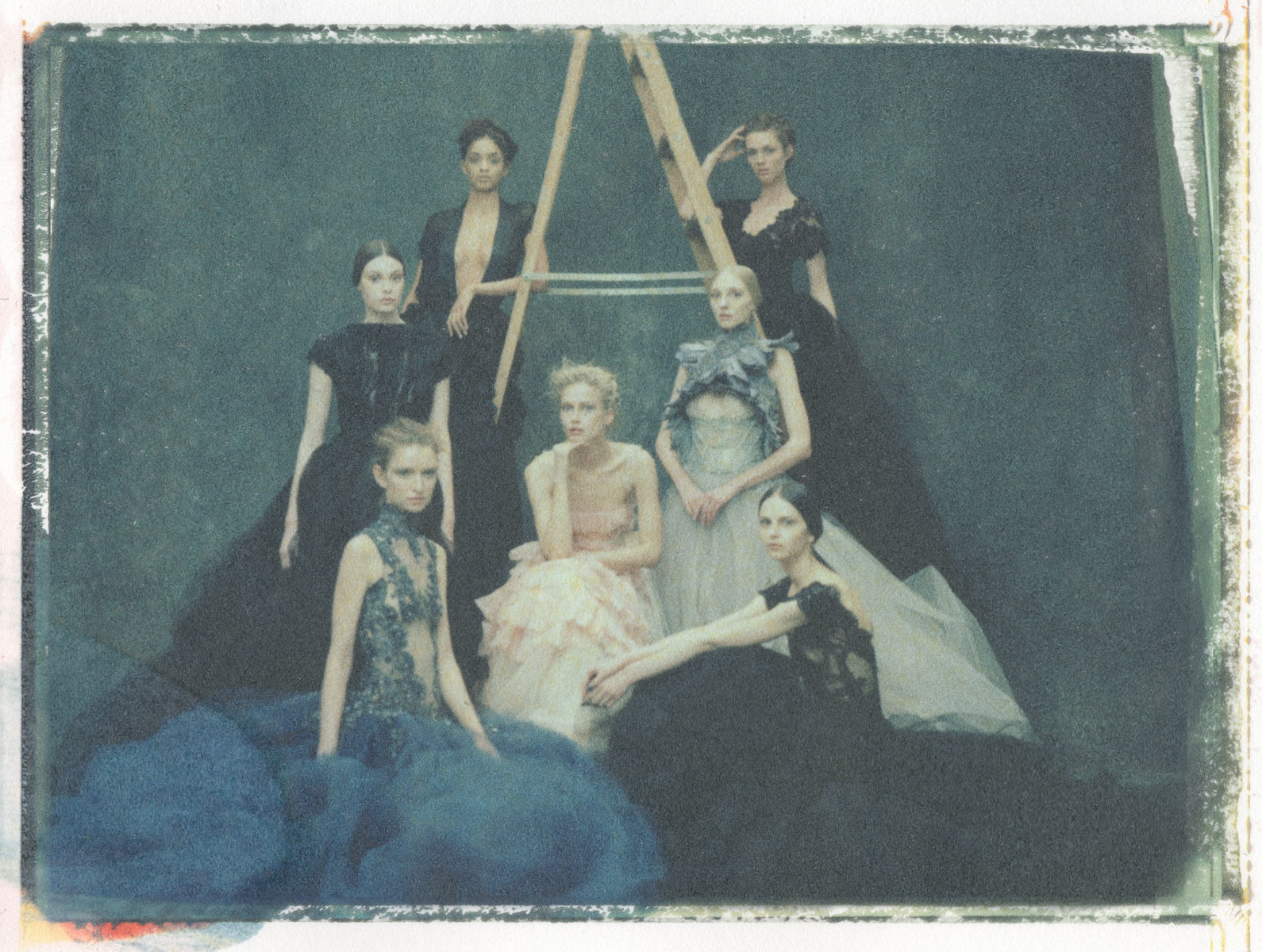 A softly rendered figure in a formal gown on instant film.