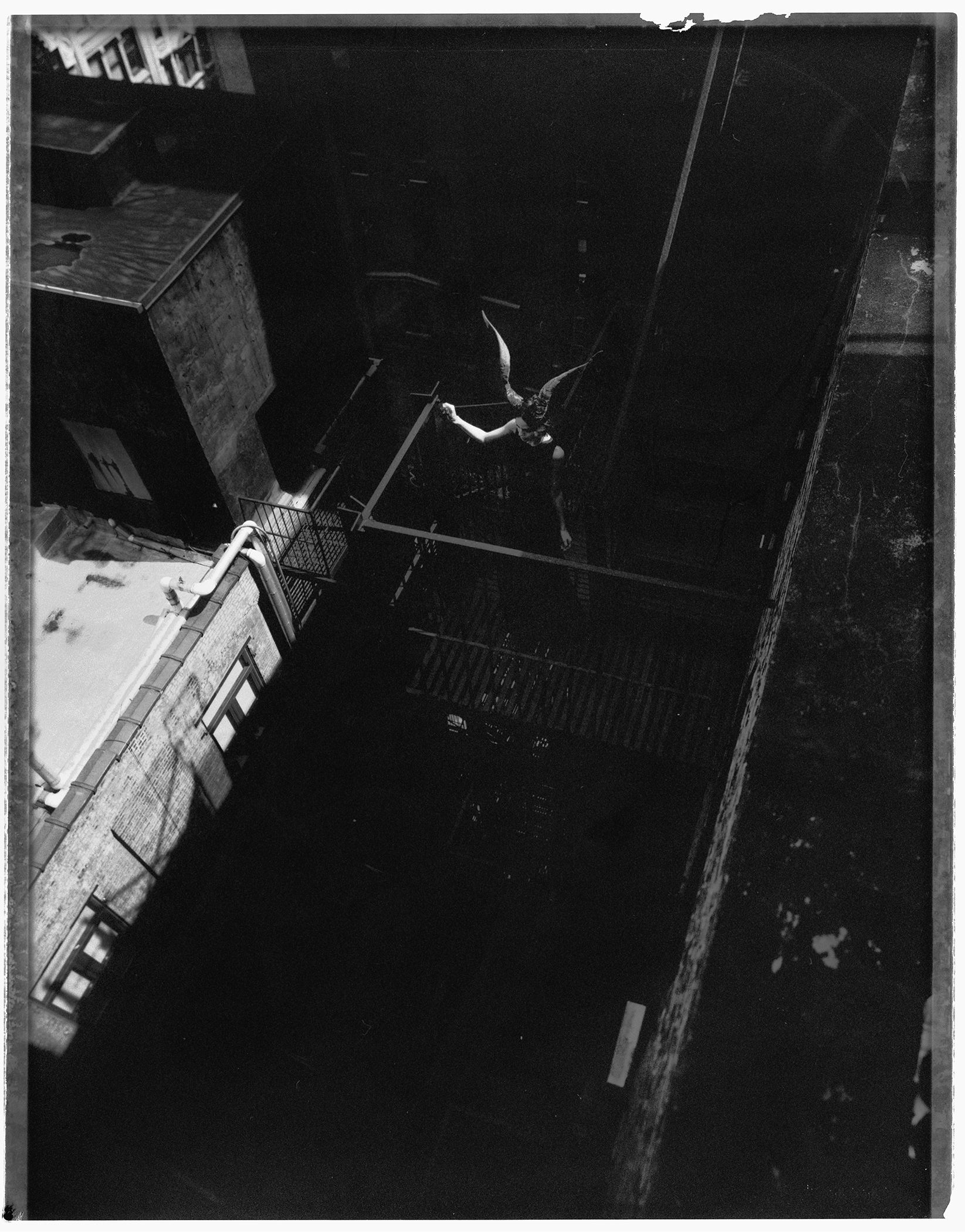 A figure photographed on a New York rooftop in an instant-film study.