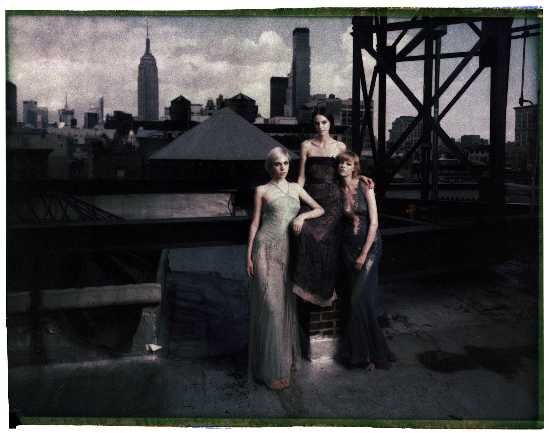 Fashion figures inhabit a New York rooftop inside marked film frames.