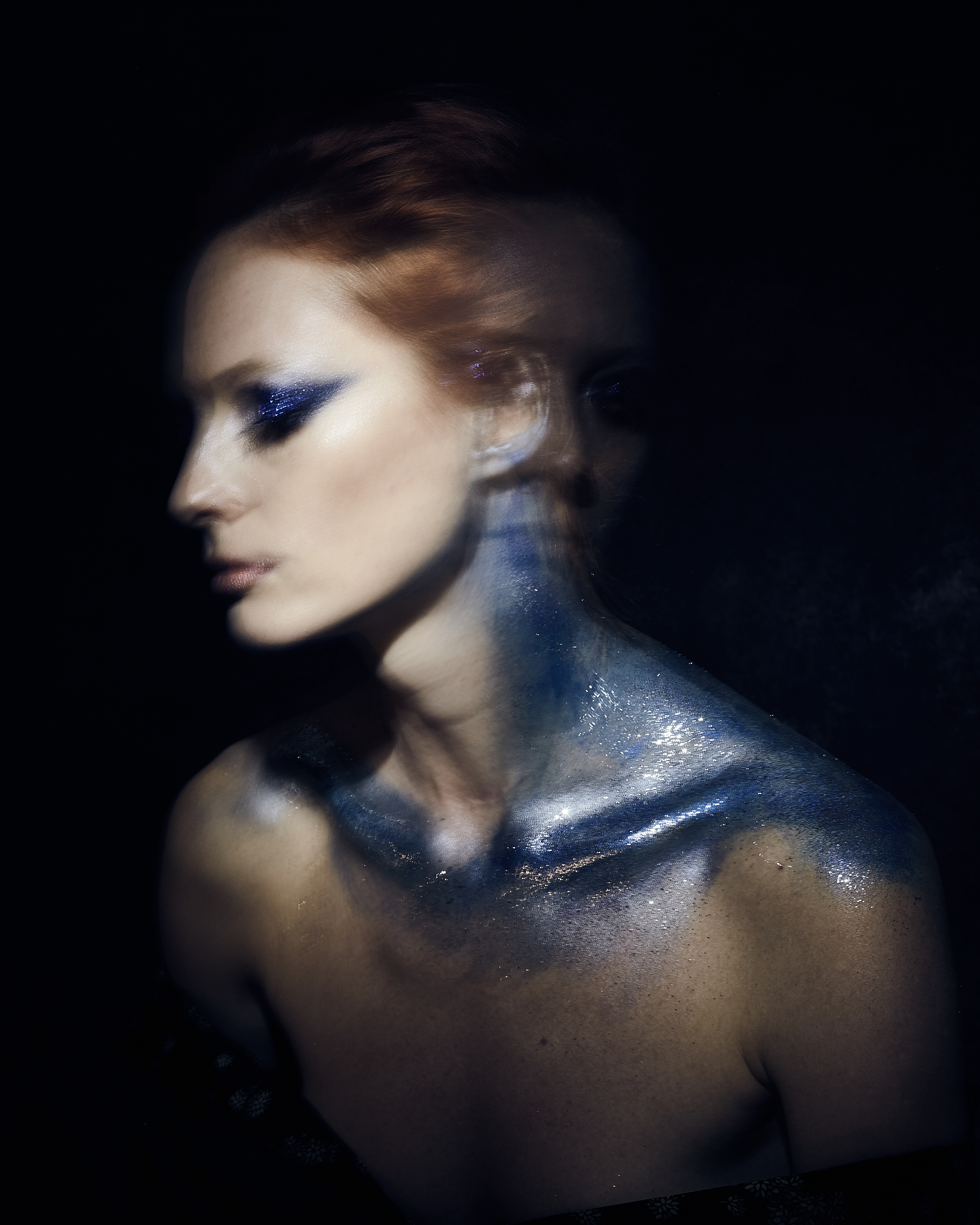 A portrait emerging from darkness through painterly light.