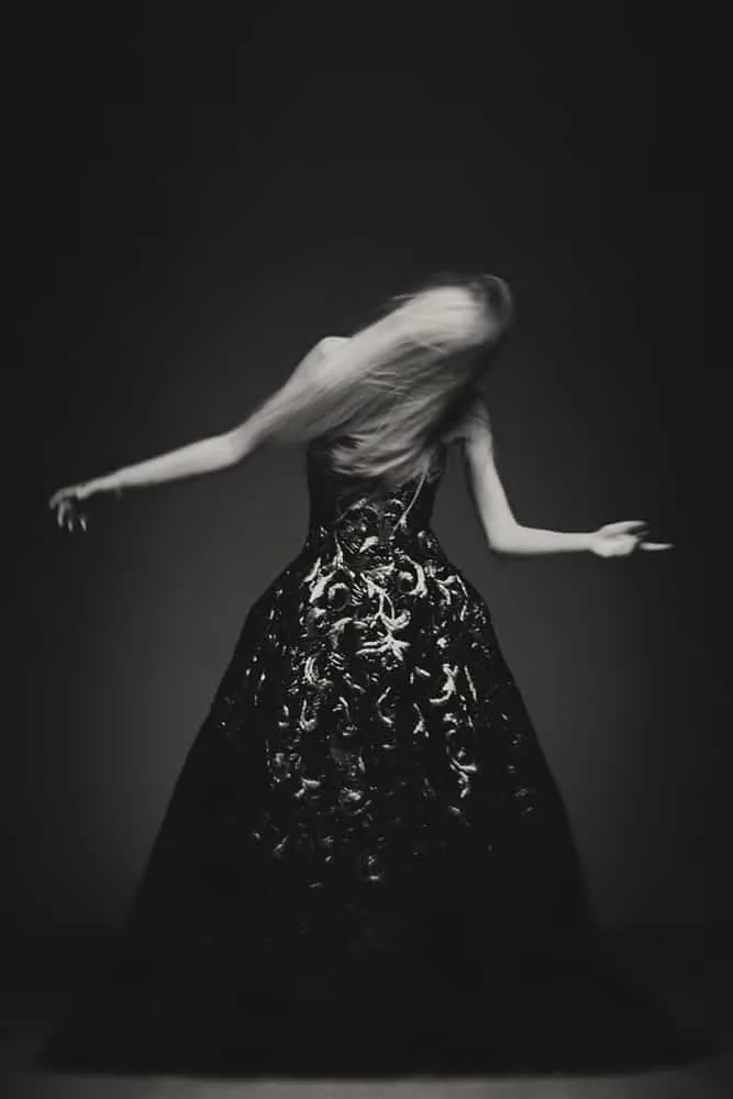 A couture gown blurred in motion during a fashion study.