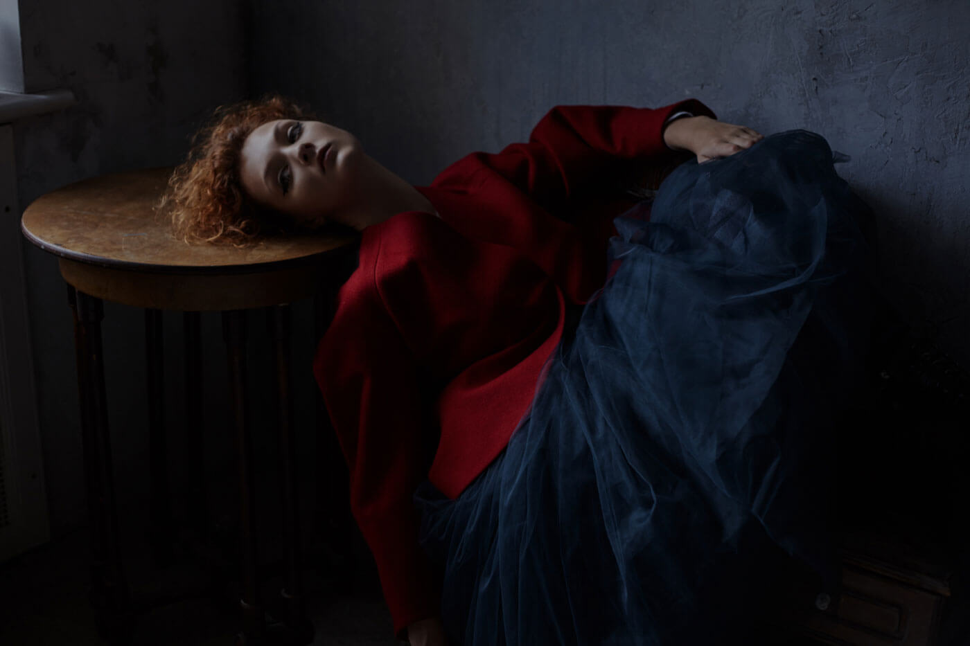 A draped fashion figure in an architectural interior.